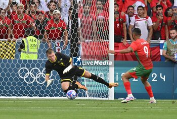 2024-07-27 - Kiril Fesiun (Ukraine) and Soufiane Rahimi (Morocco), Football, Men's Group B between Ukraine and Morocco during the Olympic Games Paris 2024 on 27 July 2024 at Geoffroy-Guichard Stadium in Saint-Etienne, France - OLYMPIC GAMES PARIS 2024 - 27/07 - OLYMPIC GAMES PARIS 2024 - OLYMPIC GAMES