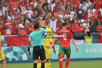 2024-07-27 - Said Martinez (referee) gives a red card to Volodymyr Salyuk (Ukraine), Football, Men's Group B between Ukraine and Morocco during the Olympic Games Paris 2024 on 27 July 2024 at Geoffroy-Guichard Stadium in Saint-Etienne, France - OLYMPIC GAMES PARIS 2024 - 27/07 - OLYMPIC GAMES PARIS 2024 - OLYMPIC GAMES