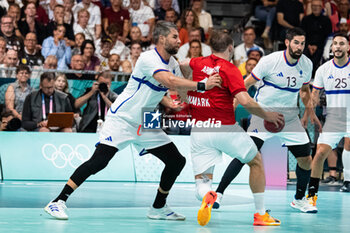 2024-07-27 - Lucas Karabatic (France) and Thomas Arnoldsen (Denmark), Handball, Men's Preliminary Round Group B between Denmark and France during the Olympic Games Paris 2024 on 27 July 2024 at South Paris Arena 6 in Paris, France - OLYMPIC GAMES PARIS 2024 - 27/07 - OLYMPIC GAMES PARIS 2024 - OLYMPIC GAMES