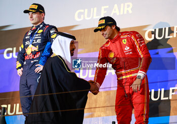 2024-03-02 - BEN SULAYEM Mohammed (uae), President of the FIA, portrait SAINZ Carlos (spa), Scuderia Ferrari SF-24, portrait podium during the Formula 1 Gulf Air Bahrain Grand Prix 2024, 1st round of the 2024 FIA Formula One World Championship from February 29 to March 2, 2024 on the Bahrain International Circuit, in Sakhir, Bahrain - F1 - BAHRAIN GRAND PRIX 2024 - FORMULA 1 - MOTORS