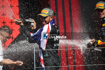 2024-07-07 - HAMILTON Lewis (gbr), Mercedes AMG F1 Team W15, portrait celebration podium with Ferrari champagne VERSTAPPEN Max (ned), Red Bull Racing RB20, portrait during the Formula 1 Qatar Airways British Grand Prix 2024, 12th round of the 2024 Formula One World Championship from July 5 to 7, 2024 on the Silverstone Circuit, in Silverstone, United Kingdom - F1 - BRITISH GRAND PRIX 2024 - FORMULA 1 - MOTORS