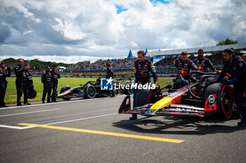 2024-07-07 - VERSTAPPEN Max (ned), Red Bull Racing RB20, and the Modified F2 car prepared by Mercedes Applied Science and Carlin for the fictional Apex APXGP team in the F1 movie by Apple Studios / Bruckheimer Films, during the Formula 1 Qatar Airways British Grand Prix 2024, 12th round of the 2024 Formula One World Championship from July 5 to 7, 2024 on the Silverstone Circuit, in Silverstone, United Kingdom - F1 - BRITISH GRAND PRIX 2024 - FORMULA 1 - MOTORS