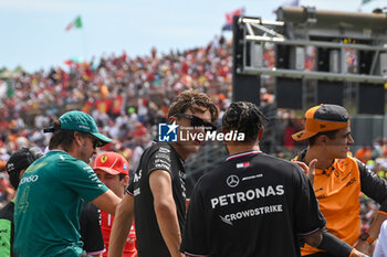 2024-07-21 - George Russell (GBR) chatting wit Lewis Hamilton (GBR) - Mercedes-AMG PETRONAS F1 Team - Mercedes W15 - Mercedes E Performance during driver parade on Raceday on Sunday, July 21, of Formula 1 Hungarian Grand Prix 2024, scheduled to take place at Hungaroring track in Mogyorod, Budapest, Hungary, july 19 to july 21, 2024 - FORMULA 1 HUNGARIAN GRAND PRIX 2024 - RACE - FORMULA 1 - MOTORS