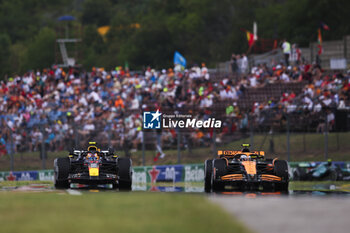 2024-07-20 - 11 PEREZ Sergio (mex), Red Bull Racing RB20, action and 04 NORRIS Lando (gbr), McLaren F1 Team MCL38, action during the Formula 1 Hungarian Grand Prix 2024, 13th round of the 2024 Formula One World Championship from July 19 to 21, 2024 on the Hungaroring, in Mogyorod, Hungary - F1 - HUNGARIAN GRAND PRIX 2024 - FORMULA 1 - MOTORS