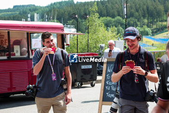 2024-07-25 - Hungry photographers Joao Filipe and Antonin Vincent eating a waffle in the paddock during the Formula 1 Rolex Belgian Grand Prix 2024, 14th round of the 2024 Formula One World Championship from July 26 to 28, 2024 on the Circuit de Spa-Francorchamps, in Stavelot, Belgium - F1 - BELGIAN GRAND PRIX 2024 - FORMULA 1 - MOTORS