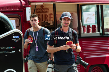 2024-07-25 - Hungry photographers Joao Filipe and Antonin Vincent eating a waffle in the paddock during the Formula 1 Rolex Belgian Grand Prix 2024, 14th round of the 2024 Formula One World Championship from July 26 to 28, 2024 on the Circuit de Spa-Francorchamps, in Stavelot, Belgium - F1 - BELGIAN GRAND PRIX 2024 - FORMULA 1 - MOTORS