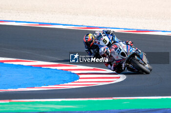 2024-06-15 - (31) Garret Gerloff from United States of America of Bonovo Action BMW Team, rides BMW M1000 RR and (5) Philipp Oettl from Germany of Team GMT94 Yamaha, rides Yamaha YZF R1 in action during the FIM Motul Superbike World Championship - Free practice session of Emilia Romagna Round at Marco Simoncelli World Circuit in Misano Adriatico on June 15, 2024 in Misano Adriatico, Rimini, Italy. - PIRELLI EMILIA ROMAGNA ROUND - FREE PRACTICE - SUPERBIKE - MOTORS