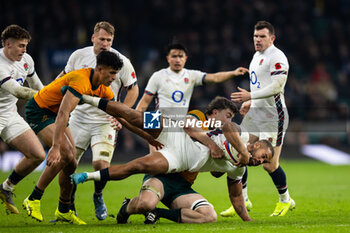 09/11/2024 - Ollie Lawrence of England is tackled by Nick Frost of Australia during the Autumn Nations Series 2024 rugby union match between England and Australia on 9 November 2024 at Allianz Stadium in Twickenham, England - RUGBY - AUTUMN NATIONS SERIES 2024 - ENGLAND V AUSTRALIA - AUTUMN NATIONS SERIES - RUGBY