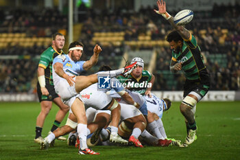 2024-01-12 - Bayonne scrum-half Maxime Machenaud (9) kicks under pressure from Northampton Saints back row Courtney Laws (6) during the Champions Cup, rugby union match between Northampton Saints and Aviron Bayonnais (Bayonne) on 12 January 2024 at Franklins Gardens in Northampton, England - RUGBY - CHAMPIONS CUP - NORTHAMPTON V BAYONNE - CHAMPIONS CUP - RUGBY