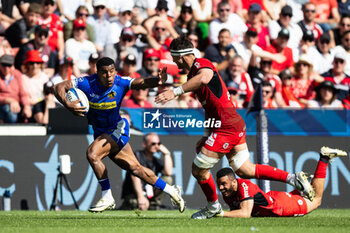 2024-04-14 - Immanuel Feyi-Waboso of Exeter Chiefs evades the tackle of Alexandre Roumat of Toulouse during the European Rugby Champions Cup, quarter final, rugby union match between Stade Toulousain (Toulouse) and Exeter Chiefs on 14 April 2024 at Stade Ernest-Wallon in Toulouse, France - RUGBY - CHAMPIONS CUP - TOULOUSE V EXETER - CHAMPIONS CUP - RUGBY