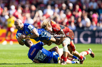 2024-04-14 - Olly Woodburn of Exeter Chiefs is tackled by Paul Costes of Toulouse during the European Rugby Champions Cup, quarter final, rugby union match between Stade Toulousain (Toulouse) and Exeter Chiefs on 14 April 2024 at Stade Ernest-Wallon in Toulouse, France - RUGBY - CHAMPIONS CUP - TOULOUSE V EXETER - CHAMPIONS CUP - RUGBY