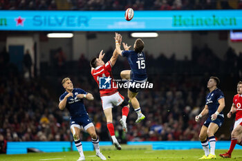 2024-02-03 - Josh Adams of Wales and Kyle Rowe of Scotland vie for the high ball during the 2024 Six nations Championship, rugby union match between Wales and Scotland on 3 February 2024 at Millenium Stadium in Cardiff, Wales - RUGBY - SIX NATIONS 2024 - WALES V SCOTLAND - SIX NATIONS - RUGBY