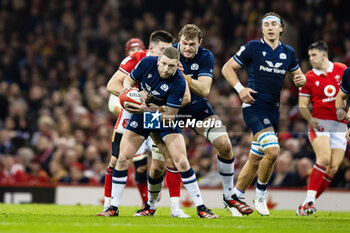 2024-02-03 - Finn Russell of Scotland under pressure from Josh Adams of Wales during the 2024 Six nations Championship, rugby union match between Wales and Scotland on 3 February 2024 at Millenium Stadium in Cardiff, Wales - RUGBY - SIX NATIONS 2024 - WALES V SCOTLAND - SIX NATIONS - RUGBY