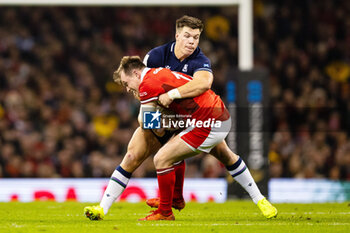 2024-02-03 - Nick Tompkins of Wales is tackled by Huw Jones of Scotland during the 2024 Six nations Championship, rugby union match between Wales and Scotland on 3 February 2024 at Millenium Stadium in Cardiff, Wales - RUGBY - SIX NATIONS 2024 - WALES V SCOTLAND - SIX NATIONS - RUGBY