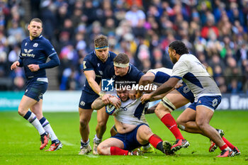 2024-02-10 - Cyril Baille of France is tackled by Scott Cummings and George Turner of Scotland during the 2024 Six nations Championship, rugby union match between Scotland and France on 10 February 2024 at Scottish Gas Murrayfield in Edinburgh, Scotland - RUGBY - SIX NATIONS 2024 - SCOTLAND V FRANCE - SIX NATIONS - RUGBY