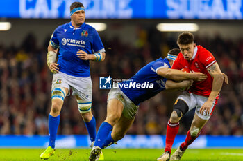 2024-03-16 - Josh Adams of Wales is tackled by Giacomo Nicotera of Italy during the 2024 Six nations Championship, rugby union match between Wales and Italy on 16 March 2024 at Millenium Stadium in Cardiff, Wales - RUGBY - SIX NATIONS 2024 - WALES V ITALY - SIX NATIONS - RUGBY
