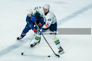 2024-04-24 - Aljosa CRNOVIC of Slovenia and Valentin CLAIREAUX of France during the International Friendly Ice Hockey match between France and Slovenia on April 24, 2024 at Aren’Ice in Cergy-Pontoise, France - ICE HOCKEY - FRIENDLY GAME - FRANCE V SLOVENIA - ICE HOCKEY - WINTER SPORTS