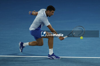 2024-01-21 - Novak Djokovic (SRB) in action during their round four singles match against Adrian Mannarino (FRA) - AUSTRALIAN OPEN - INTERNATIONALS - TENNIS