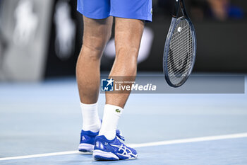 2024-01-19 - Shoes and racquet or racket of Novak Djokovic of Serbia during the Australian Open AO 2024 Grand Slam tennis tournament on January 19, 2024 at Melbourne Park in Australia. Photo Victor Joly / DPPI - TENNIS - AUSTRALIAN OPEN 2024 - WEEK 1 - INTERNATIONALS - TENNIS