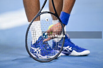 2024-01-19 - Shoes and racquet or racket of Novak Djokovic of Serbia during the Australian Open AO 2024 Grand Slam tennis tournament on January 19, 2024 at Melbourne Park in Australia. Photo Victor Joly / DPPI - TENNIS - AUSTRALIAN OPEN 2024 - WEEK 1 - INTERNATIONALS - TENNIS