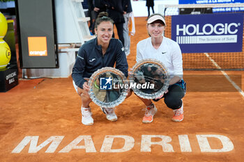 2024-05-05 - Cristina Bucsa and Sara Sorribes of Spain celebrate with the winners trophy after winning the Doubles Final against Laura Siegemund of Germany and Barbora Krejcikova of Czech Republic during the Mutua Madrid Open 2024, ATP Masters 1000 and WTA 1000, tennis tournament on May 5, 2024 at Caja Magica in Madrid, Spain - TENNIS - MUTUA MADRID OPEN 2024 - INTERNATIONALS - TENNIS