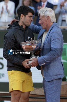 2024-06-09 - Winner Carlos Alcaraz of Spain, trophy presenter Bjorn Borg during the podium ceremony of the men's final on day 15 of the 2024 French Open, Roland-Garros 2024, Grand Slam tennis tournament on June 9, 2024 at Roland-Garros stadium in Paris, France - TENNIS - ROLAND GARROS 2024 - 09/06 - INTERNATIONALS - TENNIS