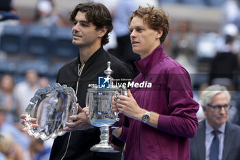 2024-09-08 - Finalist Taylor Fritz of USA, winner Jannik Sinner of Italy during the trophy ceremony of the men's final on day 14 of the 2024 US Open, Grand Slam tennis tournament on September 8, 2024 at USTA Billie Jean King National Tennis Center in Flushing Meadows, Queens, New York, United States - TENNIS - US OPEN 2024 - 08/09 - INTERNATIONALS - TENNIS