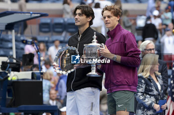 2024-09-08 - Finalist Taylor Fritz of USA, winner Jannik Sinner of Italy during the trophy ceremony of the men's final on day 14 of the 2024 US Open, Grand Slam tennis tournament on September 8, 2024 at USTA Billie Jean King National Tennis Center in Flushing Meadows, Queens, New York, United States - TENNIS - US OPEN 2024 - 08/09 - INTERNATIONALS - TENNIS