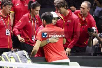 2024-11-19 - Carlos Alcaraz of Spain hugs Rafael Nadal after his victory against Tallon Griekspoor of Netherlands during the 2024 Davis Cup Finals quarter-final tennis tie between Netherlands and Spain at Palacio de Deportes Jose Maria Martin Carpena on 19 November 2024 in Malaga, Spain - TENNIS - DAVIS CUP 2024 - 1/4 - NETHERLANDS V SPAIN - INTERNATIONALS - TENNIS