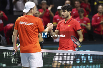 2024-11-19 - Carlos Alcaraz of Spain (R) shakes hands with Tallon Griekspoor of Netherlands after his victory during the 2024 Davis Cup Finals quarter-final tennis tie between Netherlands and Spain at Palacio de Deportes Jose Maria Martin Carpena on 19 November 2024 in Malaga, Spain - TENNIS - DAVIS CUP 2024 - 1/4 - NETHERLANDS V SPAIN - INTERNATIONALS - TENNIS