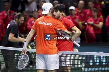 2024-11-19 - Carlos Alcaraz of Spain (R) shakes hands with Tallon Griekspoor of Netherlands after his victory during the 2024 Davis Cup Finals quarter-final tennis tie between Netherlands and Spain at Palacio de Deportes Jose Maria Martin Carpena on 19 November 2024 in Malaga, Spain - TENNIS - DAVIS CUP 2024 - 1/4 - NETHERLANDS V SPAIN - INTERNATIONALS - TENNIS