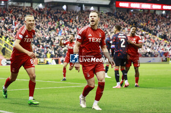 2025-02-26 - Nicky Devlin (2) of Aberdeen scores a goal 1-0 and celebrates during the Scottish championship Premiership football match between Aberdeen and Rangers on 30 October 2024 at Pittodrie Stadium in Aberdeen, Scotland - FOOTBALL - SCOTTISH CHAMP - ABERDEEN V RANGERS - SCOTTISH PREMIERSHIP - SOCCER