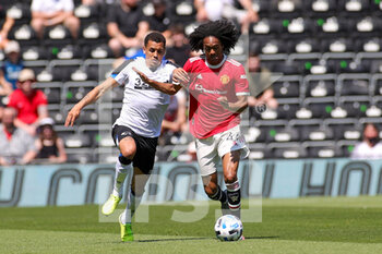 2021-07-18 - Tahith Chong (44) of Manchester United tussles with Festy Ebosele (29) of Derby County during the Pre-Season Friendly football match between Derby County and Manchester United on July 18, 2021 at the Pride Park in Derby, England - Photo Nigel Keene / ProSportsImages / DPPI - FRIENDLY MATCH BETWEEN DERBY COUNTY AND MANCHESTER UNITED  - FRIENDLY MATCH - SOCCER