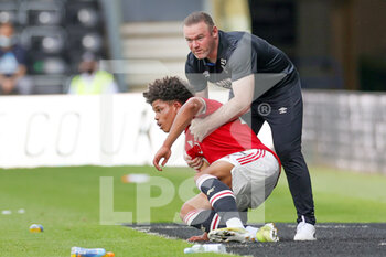 2021-07-18 - Wayne Rooney Manager of Derby County helps up Shola Shoretire (47) of Manchester United during the Pre-Season Friendly football match between Derby County and Manchester United on July 18, 2021 at the Pride Park in Derby, England - Photo Nigel Keene / ProSportsImages / DPPI - FRIENDLY MATCH BETWEEN DERBY COUNTY AND MANCHESTER UNITED  - FRIENDLY MATCH - SOCCER