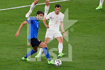 2021-06-16 - Manuel Locatelli of Italy and Remo Freuler of Switzerland seen in action during the UEFA Euro 2020 Group A - Italy vs Switzerland at the Olimpic Stadium in Rome. - UEFA EURO 2020 GROUP A - ITALY VS SWITZERLAND - UEFA EUROPEAN - SOCCER