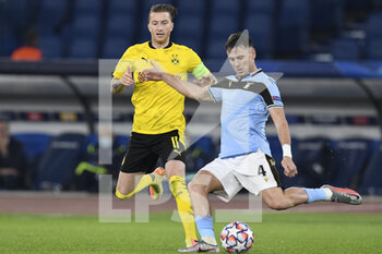 2020-10-20 - ROME, ITALY - October 20 : Marco Reus (L) of Borussia Dortmund in action against Patric Gabarron (R) of SS Lazio during the UEFA Champions League group f  soccer match between SS Lazio and Borussia Dortmund Stadio Olimpico on October 20,2020 in Rome Italy - SS LAZIO VS BORUSSIA DORTMUND - UEFA CHAMPIONS LEAGUE - SOCCER