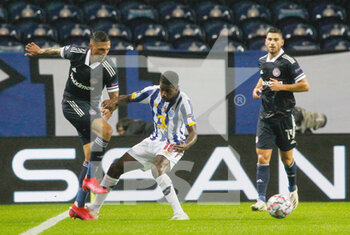 2020-10-27 - Jose Holebas of Olympiacos (L) in action with Wilson Manafa of Porto during the UEFA Champions League, Group Stage, Group C football match between FC Porto and Olympiacos on October 27, 2020 at Estadio do Dragao in Porto, Portugal - Photo Nuno Guimaraes / ProSportsImages / DPPI - FC PORTO VS OLYMPIACOS - UEFA CHAMPIONS LEAGUE - SOCCER