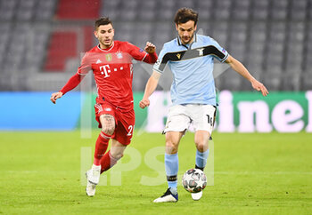2021-03-17 - Marco Parolo of Lazio and Lucas Hernandez of Bayern Munich during the UEFA Champions League, round of 16, 2nd leg football match between Bayern Munich and SS Lazio on March 17, 2021 at Allianz Arena in Munich, Germany - Photo Lennart Preiss / Witters / firo sportphoto / DPPI - BAYERN MUNICH AND SS LAZIO - UEFA CHAMPIONS LEAGUE - SOCCER