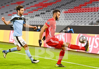 2021-03-17 - Eric Maxim Choupo-Moting of Bayern Munich and Marco Parolo of Lazio during the UEFA Champions League, round of 16, 2nd leg football match between Bayern Munich and SS Lazio on March 17, 2021 at Allianz Arena in Munich, Germany - Photo Lennart Preiss / Witters / firo sportphoto / DPPI - BAYERN MUNICH AND SS LAZIO - UEFA CHAMPIONS LEAGUE - SOCCER