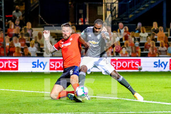 2020-09-22 - Luton Town defender Sonny Bradley (5) challenges Manchester United forward Odion Ighalo (25) during the English League Cup, EFL Carabao Cup, football match between Luton Town and Manchester United on September 22, 2020 at Kenilworth Road in Luton, England - Photo Nigel Keene / ProSportsImages / DPPI - LUTON TOWN VS MANCHESTER UNITED - ENGLISH LEAGUE CUP - SOCCER