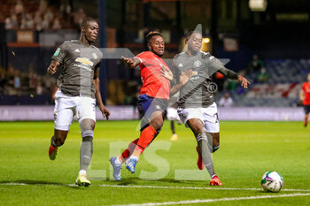2020-09-22 - Manchester United defender Eric Bailly (3) and Manchester United defender Aaron Wan-Bissaka (29) shepherd Luton Town midfielder Kazenga LuaLua (25) off the ball during the English League Cup, EFL Carabao Cup, football match between Luton Town and Manchester United on September 22, 2020 at Kenilworth Road in Luton, England - Photo Nigel Keene / ProSportsImages / DPPI - LUTON TOWN VS MANCHESTER UNITED - ENGLISH LEAGUE CUP - SOCCER
