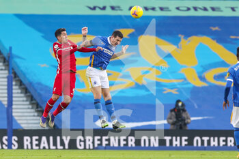 2020-11-28 - Brighton and Hove Albion defender Lewis Dunk (5) wins ball in the air with header from Liverpool forward Roberto Firmino (9) during the English championship, Premier League football match between Brighton and Hove Albion and Liverpool on November 28, 2020 at the American Express Community Stadium in Brighton and Hove, England - Photo Phil Duncan / ProSportsImages / DPPI - BRIGHTON AND HOVE ALBION VS LIVERPOOL - ENGLISH PREMIER LEAGUE - SOCCER