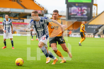 2021-01-16 - Kamil Grosicki (13) of West Bromwich Albion holds off Leander Dendoncker (32) of Wolverhampton Wanderers during the English championship Premier League football match between Wolverhampton Wanderers and West Bromwich Albion on January 16, 2021 at Molineux stadium in Wolverhampton, England - Photo Nigel Keene / ProSportsImages / DPPI - WOLVERHAMPTON WANDERERS VS WEST BROMWICH ALBION - ENGLISH PREMIER LEAGUE - SOCCER