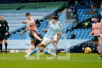 2021-01-30 - Sheffield United forward Rhian Brewster (24) takes a shot as Manchester City defender Ruben Dias (3) blocks during the English championship Premier League football match between Manchester City and Sheffield United on January 30, 2021 at the Etihad Stadium in Manchester, England - Photo Malcolm Bryce / ProSportsImages / DPPI - MANCHESTER CITY AND SHEFFIELD UNITED - ENGLISH PREMIER LEAGUE - SOCCER