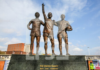 2021-04-04 - George Best, Dennis Law, Bobby Charlton Statue outside Old Trafford ahead of the English championship Premier League football match between Manchester United and Brighton and Hove Albion on April 4, 2021 at Old Trafford in Manchester, England - Photo Phil Duncan / ProSportsImages / DPPI - MANCHESTER UNITED VS BRIGHTON AND HOVE ALBION - ENGLISH PREMIER LEAGUE - SOCCER
