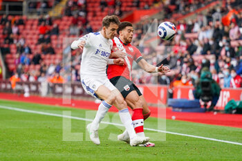 2021-05-18 - Leeds United defender Diego Llorente (14) and Southampton forward Che Adams (10) during the English championship Premier League football match between Southampton and Leeds United on May 18, 2021 at the St Mary's Stadium in Southampton, England - Photo Malcolm Bryce / ProSportsImages / DPPI - SOUTHAMPTON VS LEEDS UNITED - ENGLISH PREMIER LEAGUE - SOCCER