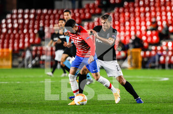 2020-10-29 - Yangel Herrera of Granada and Stefan Schwab of Paok during the UEFA Europa League, Group Stage, Group E football match between Granada CF and Paok FC on October 29, 2020 at Los Carmenes Stadium in Granada, Spain - Photo Joaquin Corchero / Spain DPPI / DPPI - GRANADA CF VS PAOK FC - UEFA EUROPA LEAGUE - SOCCER