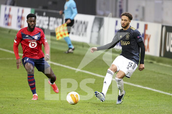2021-02-18 - Devyne Rensch of Ajax, Jonathan Bamba of Lille (left) during the UEFA Europa League, round of 32, 1st leg football match between Lille OSC (LOSC) and AFC Ajax Amsterdam on February 18, 2021 at Stade Pierre Mauroy in Villeneuve-d'Ascq near Lille, France - Photo Jean Catuffe / DPPI - LILLE OSC (LOSC) AND AFC AJAX AMSTERDAM - UEFA EUROPA LEAGUE - SOCCER
