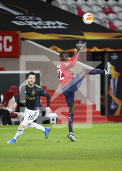 2021-02-18 - Timothy Weah of Lille, Nicolas Tagliafico of Ajax (left) during the UEFA Europa League, round of 32, 1st leg football match between Lille OSC (LOSC) and AFC Ajax Amsterdam on February 18, 2021 at Stade Pierre Mauroy in Villeneuve-d'Ascq near Lille, France - Photo Jean Catuffe / DPPI - LILLE OSC (LOSC) AND AFC AJAX AMSTERDAM - UEFA EUROPA LEAGUE - SOCCER