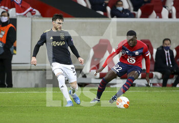 2021-02-18 - Nicolas Tagliafico of Ajax, Timothy Weah of Lille during the UEFA Europa League, round of 32, 1st leg football match between Lille OSC (LOSC) and AFC Ajax Amsterdam on February 18, 2021 at Stade Pierre Mauroy in Villeneuve-d'Ascq near Lille, France - Photo Jean Catuffe / DPPI - LILLE OSC (LOSC) AND AFC AJAX AMSTERDAM - UEFA EUROPA LEAGUE - SOCCER